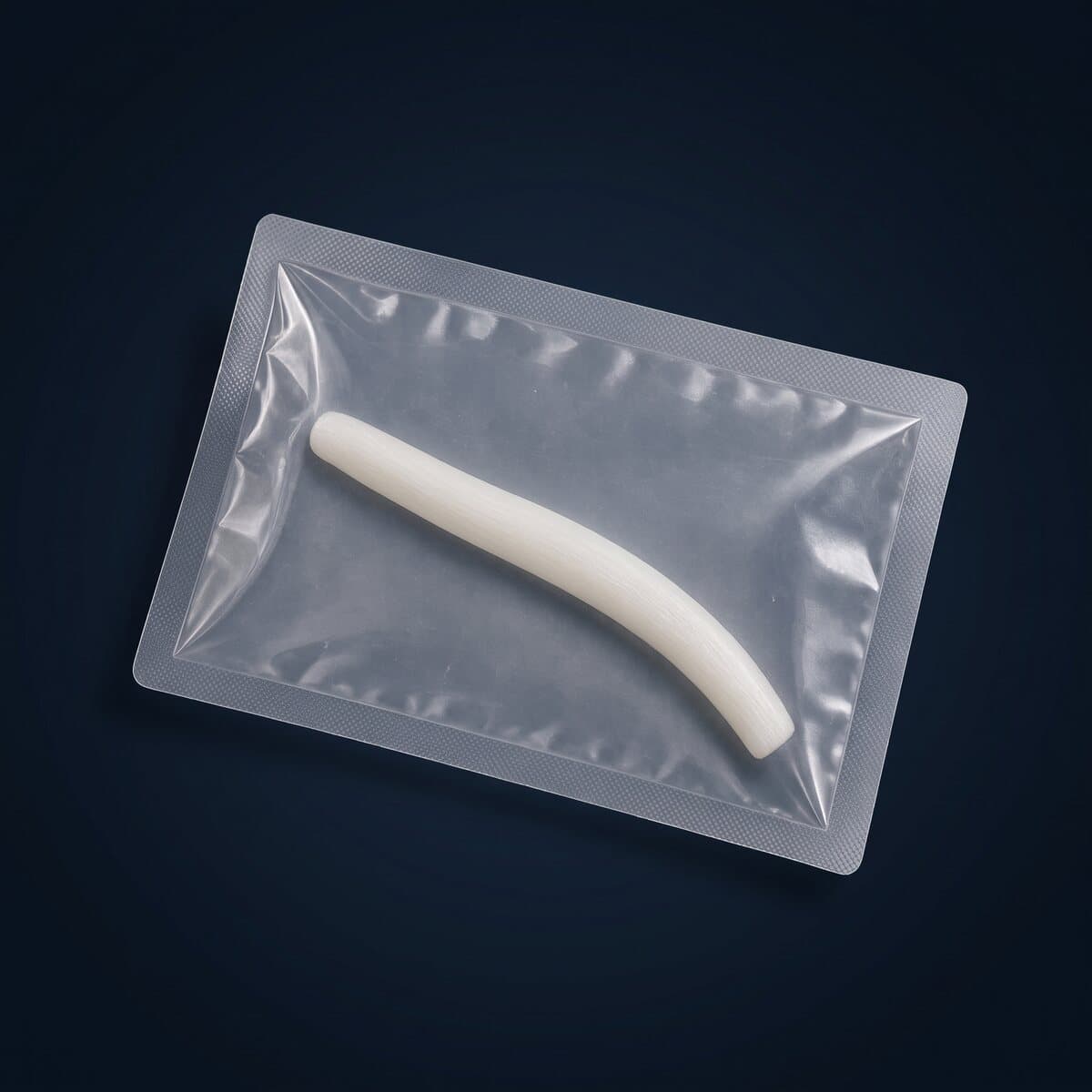 A pale tendon graft sealed in a clear medical pouch